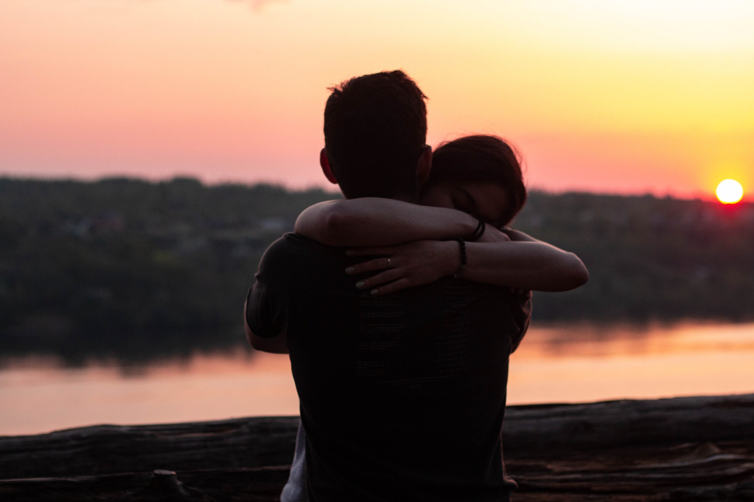 Sunset and two people hugging